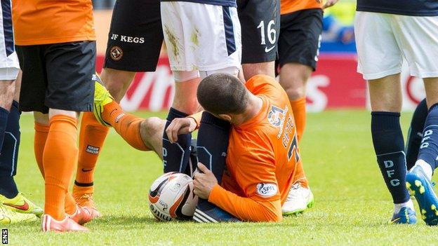 Dundee United's Nadir Ciftci clashes with Dundee's Jim McAlister