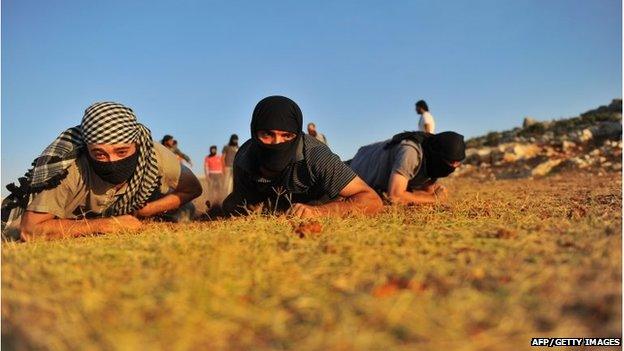 Members of Jihadist group Hamza Abdualmuttalib train near Aleppo on July 19, 2012