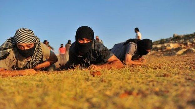 Members of Jihadist group Hamza Abdualmuttalib train near Aleppo on July 19, 2012