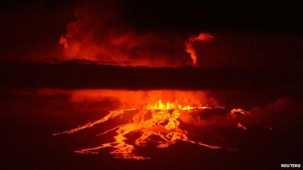 The Wolf volcano spews smoke and lava on Isabela Island, 25 May 2015