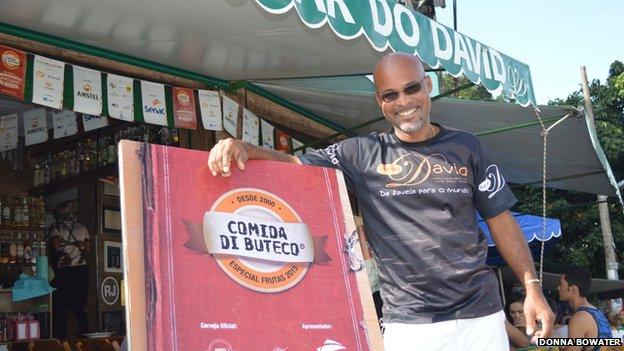 David Bispo standing outside his boteco, Bar do David