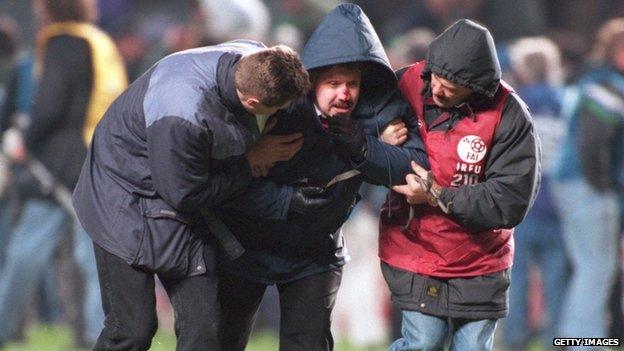 An injured Irish fan being helped during the 1995 riot at an England v Republic of Ireland march in Dublin