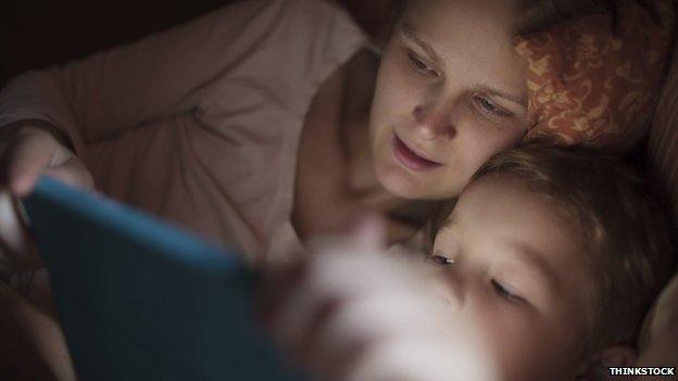 Parent and child with tablet