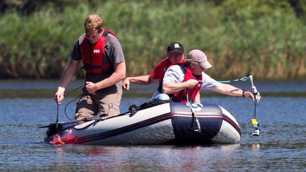 Three men in a boat