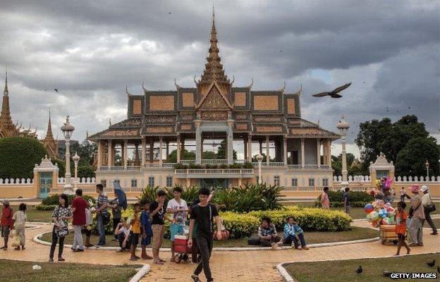 A group of Cambodian street vendors sells goods to tourists and local people in front of the Royal Palace