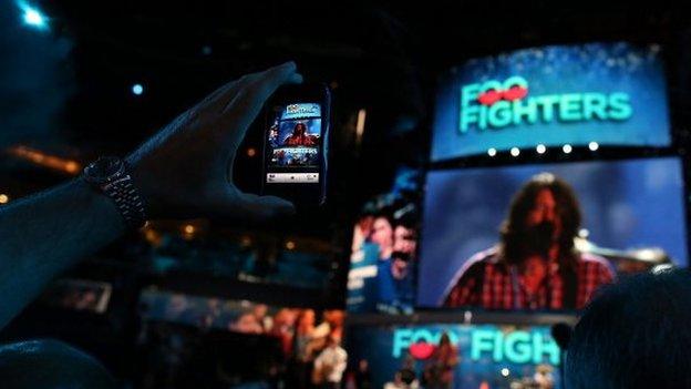 Foo Fighters being filmed on a mobile phone