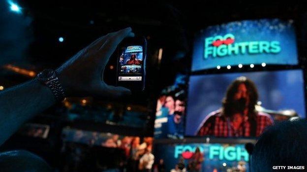 Foo Fighters being filmed on a mobile phone