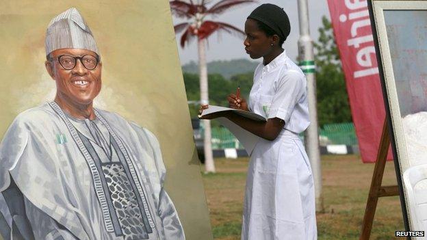 An art student takes part in a competition by drawing a portrait of President-elect Muhammad Buhari