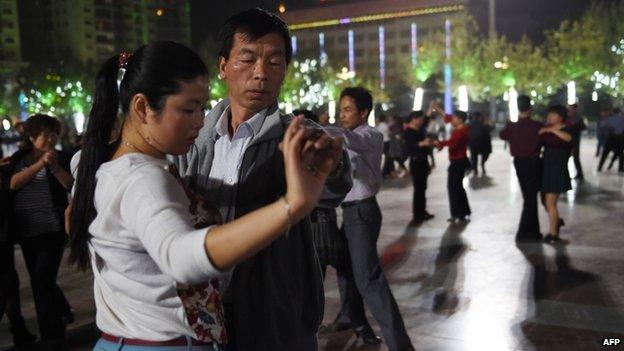 This photo taken on April 15, 2015 shows Han Chinese dancing in the central square in Hotan, in China's western Xinjiang region