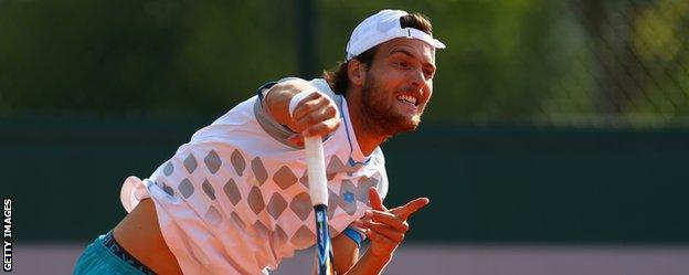 Joao Sousa in action against Jamie Murray and John Peers