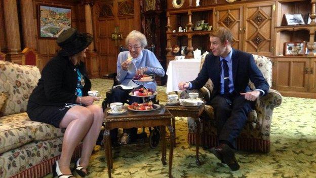 Winnie having tea in the parlour