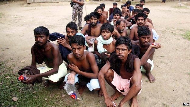 Rohingya Muslims from Bangladesh rescued by the Myanmar navy sit together at a temporary refugee camp in the village of Aletankyaw in Myanmar, 23 May 2015