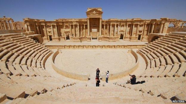 Tourists take pictures at the ancient Palmyra theatre in the historical city of Palmyra on 18 April 2008.