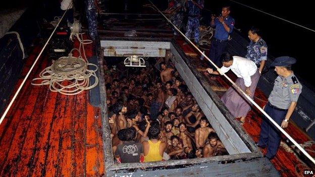 Myanmar police officers on a fishing boat with migrants at western coast, Rakhine, Myanmar, 22 May 2015