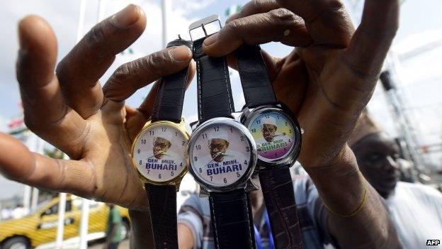 A vendor sells wrist watches with portraits of Nigerian President-elect Muhammadu Buhari ahead of the handover ceremony in Abuja, on 28 May 2015