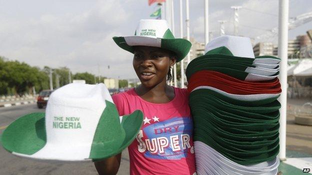 A woman sells hats ahead of the presidential inauguration of former General Muhammadu Buhari, in Abuja (28 May 2015)