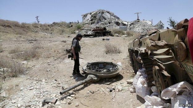 A rebel fighter from the Ahrar al-Sham Islamic Movement inspects a military post used by forces loyal to Syria's President Bashar al-Assad in Jabal al-Arbaeen, after the rebels said that they took control of the area, in Idlib countryside 26 May, 2015