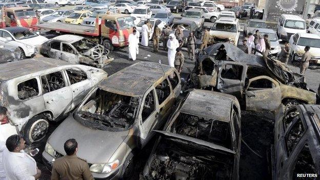 Policemen inspect a site where a car exploded near a Shia mosque in Saudi Arabia's Dammam May 29, 2015.