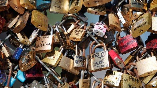 This April 9, 2014 file photo shows love locks fixed on the Pont des Arts bridge in Paris, France