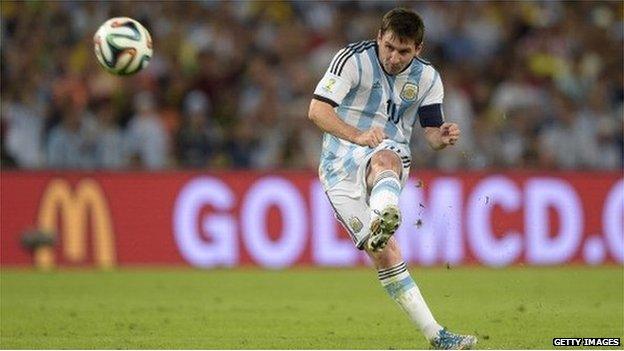 Lionel Messi in action for Argentina at the 2014 World Cup in front of a McDonald's advert