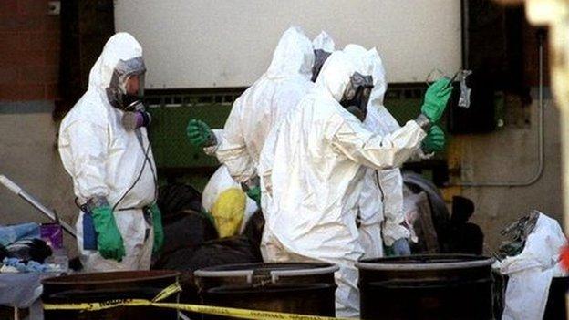 Hazardous materials workers prepare to enter the still-closed Brentwood Mail facility in Washington 25 October 2001