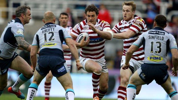 Wigan skipper Sean O'Loughlin runs into a brick wall of Leeds players at Headingley