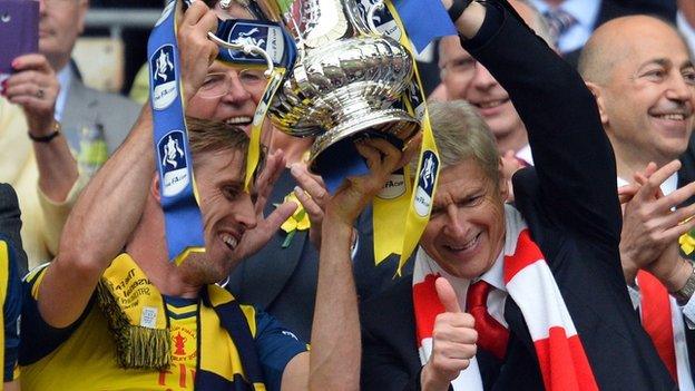 Arsene Wenger and Nacho Monreal celebrate with the FA Cup trophy