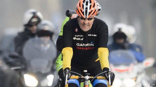 US Secretary of State John Kerry rides his bike during a break in Lausanne on 16 March 2015