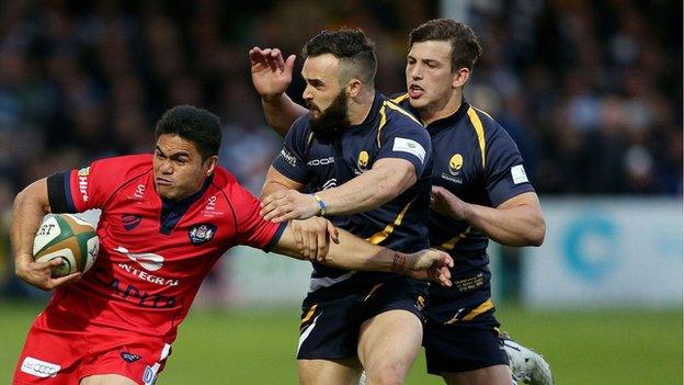 JB Bruzulier and Ryan Mills attempt to halt former Warriors winger David Lemi