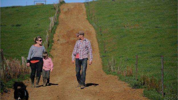 Andy (left) and Matt Jackman and their son on their Red Cow dairy farm
