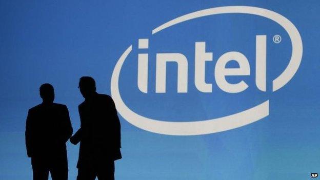 People in front of Intel logo