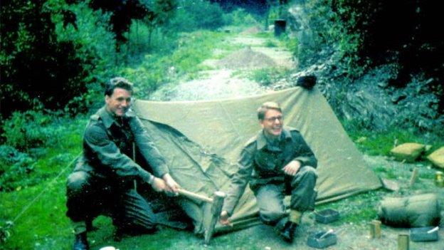 Vaughan and friend assembling a tent