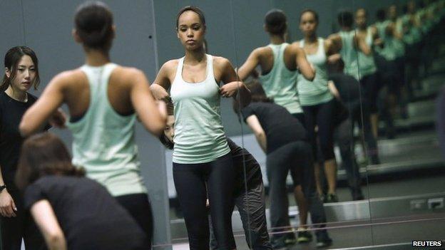 Miss Universe Japan Ariana Miyamoto is reflected on mirrors as she works out at a gym in Tokyo April 1, 2015