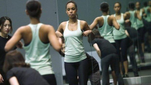 Miss Universe Japan Ariana Miyamoto is reflected on mirrors as she works out at a gym in Tokyo April 1, 2015