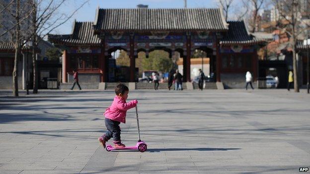 A child plays on a scooter in China