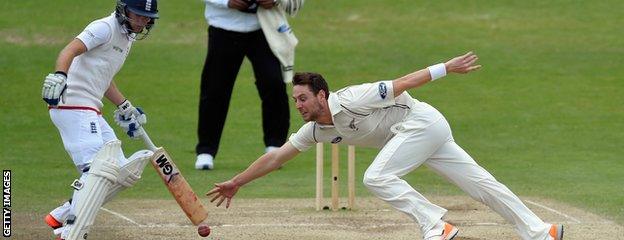 Matt Henry (right) fields off his own bowling