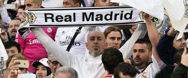 Real Madrid fans hold scarves