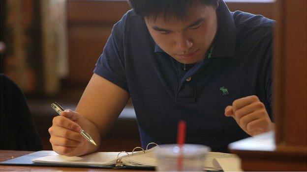 Jayden studying at UIUC seated at table