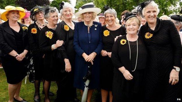 The Duchess of Cornwall poses for a photo with the WI's Calendar Girls