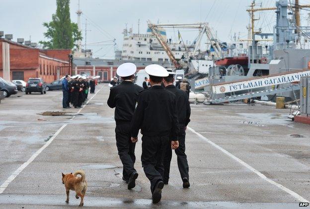 Ukrainian sailors walk past their warships in the southern Ukrainian city Odessa, on 3 May 2015