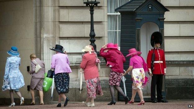 Members of the Women's Institute arrive at Buckingham Palace in London to attend a garden party hosted by the Duchess of Cornwall to mark their centenary