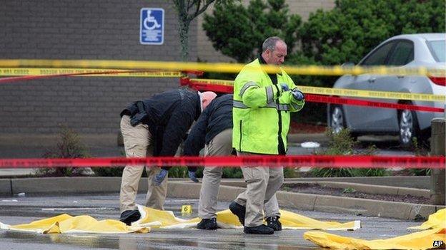 Investigators inspect the crime scene