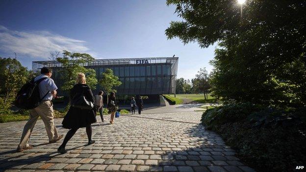 Fifa employees walk towards the Fifa headquarters on 3 June 2015 in Zurich.