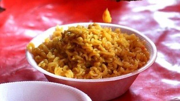 An Indian youth prepares Nestle "Maggi" instant noodles at his makeshift roadside food stall on the outskirts of New Delhi on June 3, 2015.