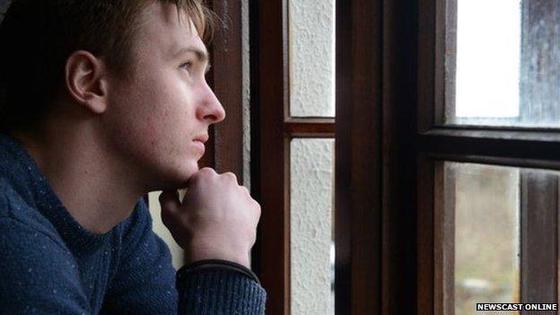 Man staring out of window