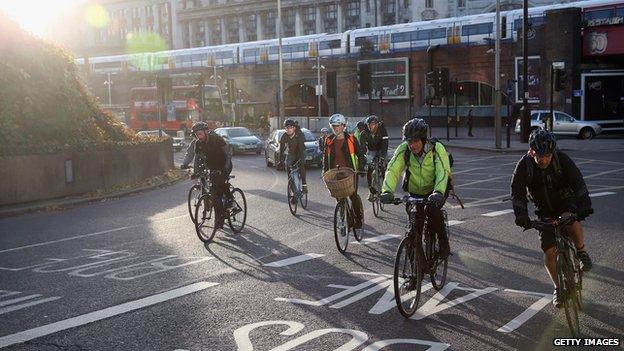 Cyclists negotiate rush hour traffic in central London near Waterloo Station