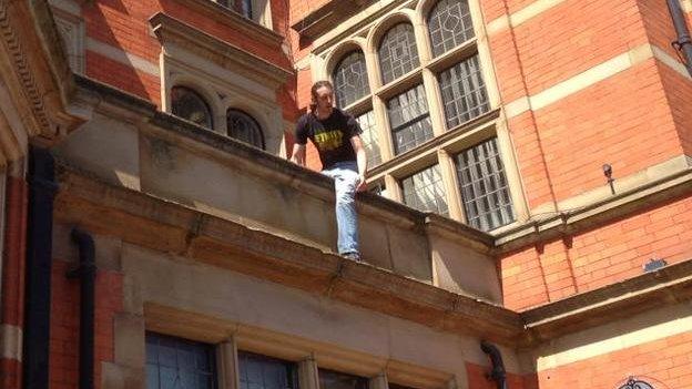 Protester climbing onto the roof of the East Riding Council offices