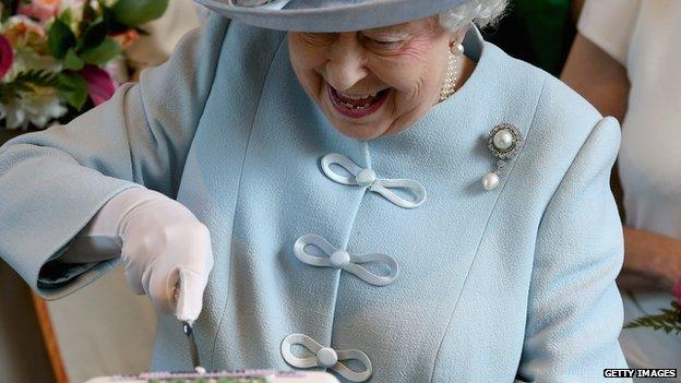 The Queen cuts a commemorative fruit cake