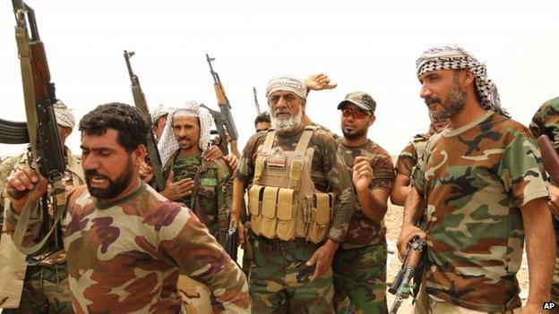 Fighters of Badr Brigades Shiite militia chant slogans against the Islamic State group at the front line, on the outskirts of Fallujah