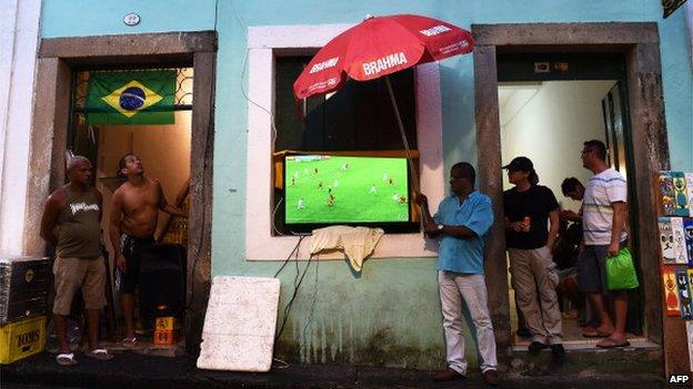 Brazilian supporters watch a live screening under the rain in Salvador De Bahia on June 18, 2014 during FIFA World Cup